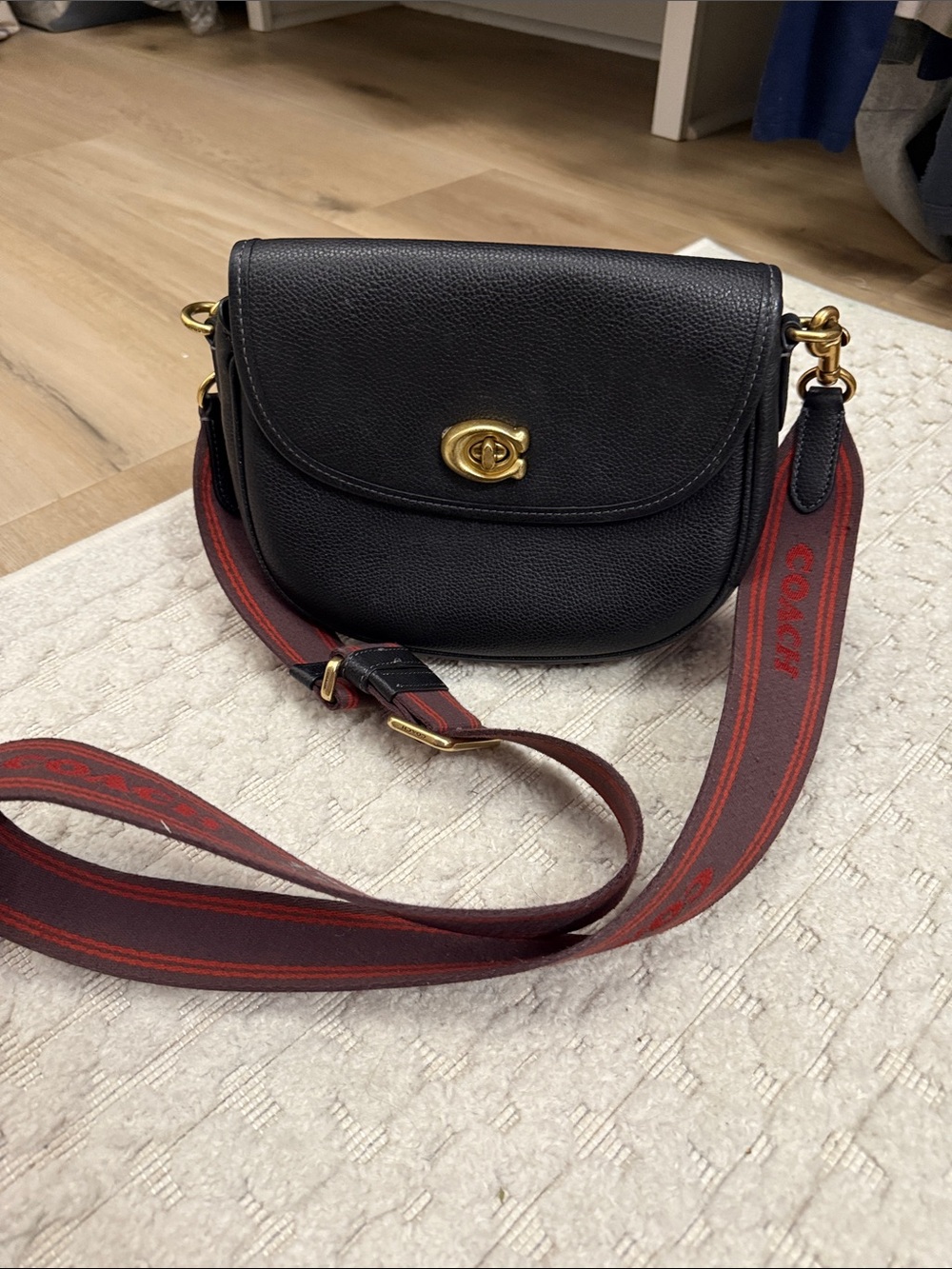 Coach Black Pebbled Leather Saddle Crossbody with Red Web Strap
